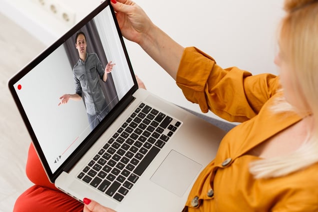 1920-close-up-of-businesswoman-video-conferencing-with-colleague-on-laptop